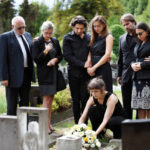 Family laying flowers on the grave